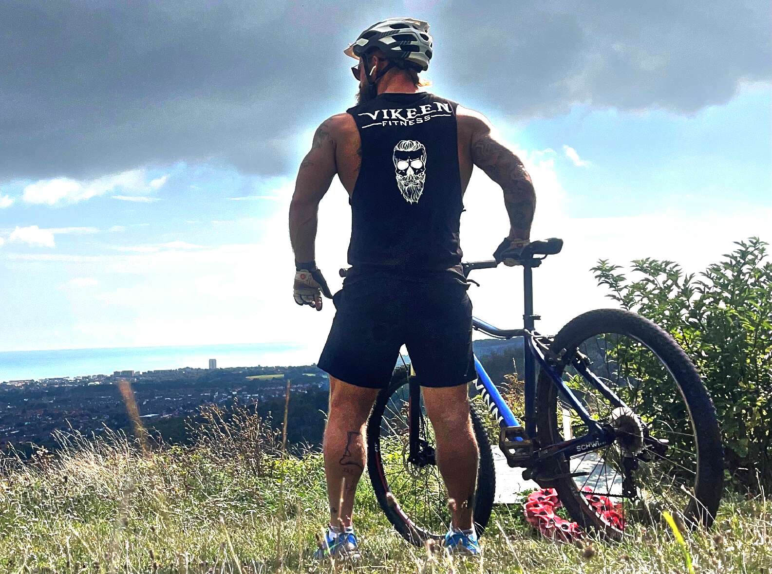 Terry Valeriano cycling on Eastbourne downs overlooking town